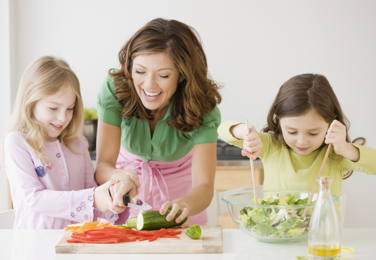 Mother and daughters preparing food